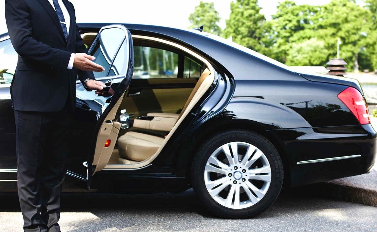 Professional chauffeur assisting passenger luxury limo service Toronto
